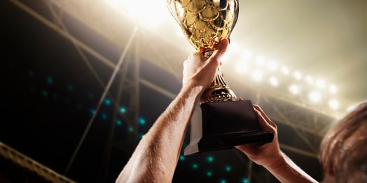 Athlete holding up a trophy that was designed through a product configurator