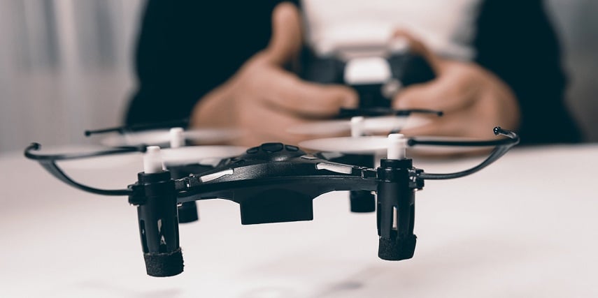 Child playing with a toy drone made in a drone configurator