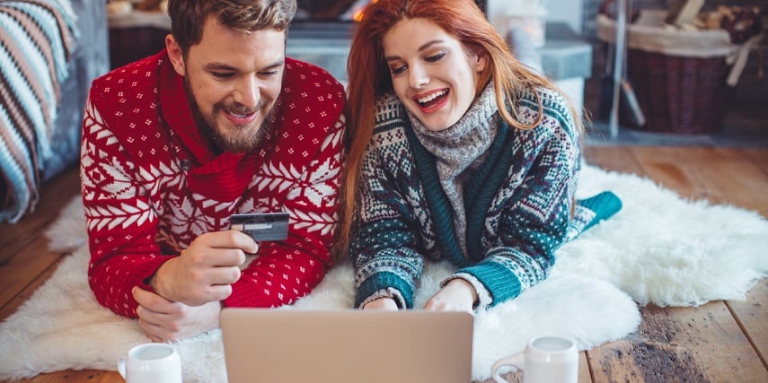 Couple using product customization tools to shop for holiday gifts