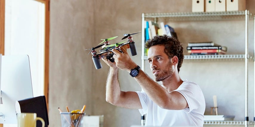 Customer holding an octocopter he made in a drone configurator