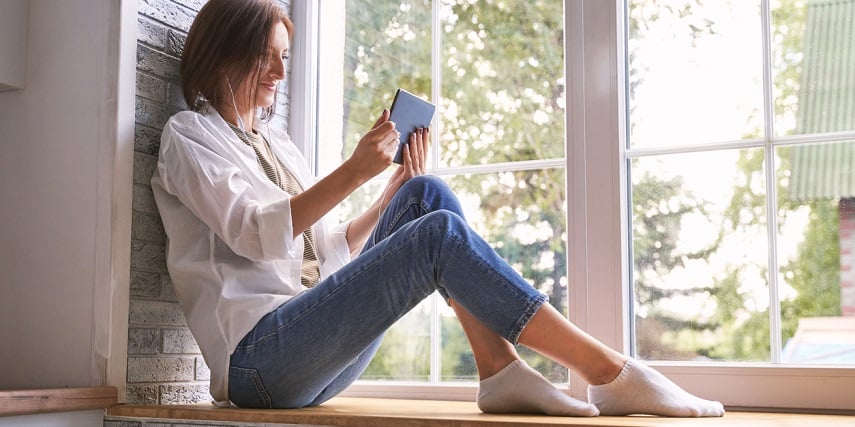 Customer on her phone after buying custom windows through a Magento product configurator