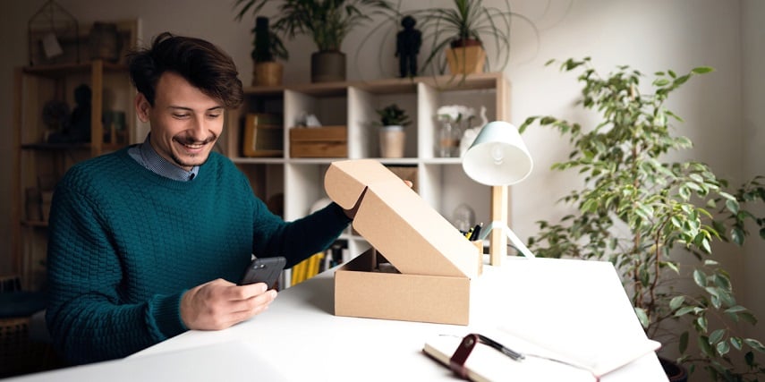 Customer opening a package of a purchase he made in a product customizer