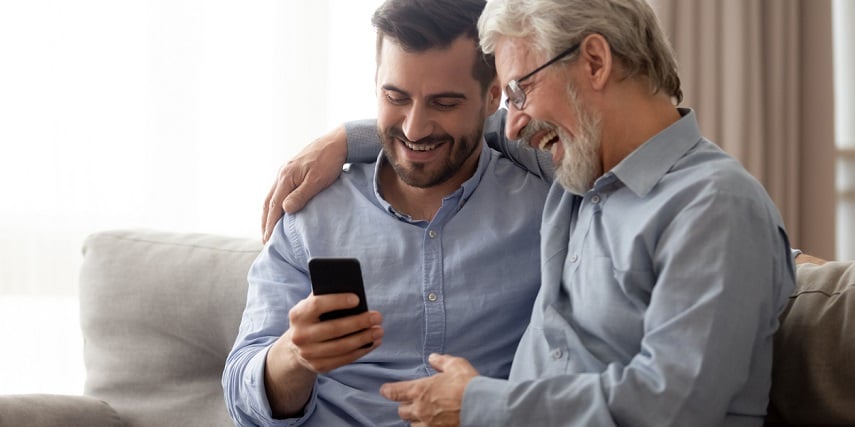 Dad and adult son browsing through a 360 product display of custom products