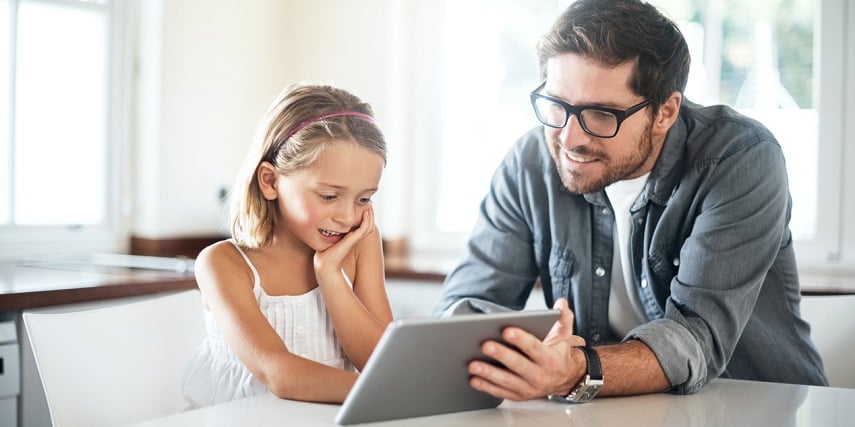 Father and daughter playing with an augmented reality in eCommerce tool on their tablet