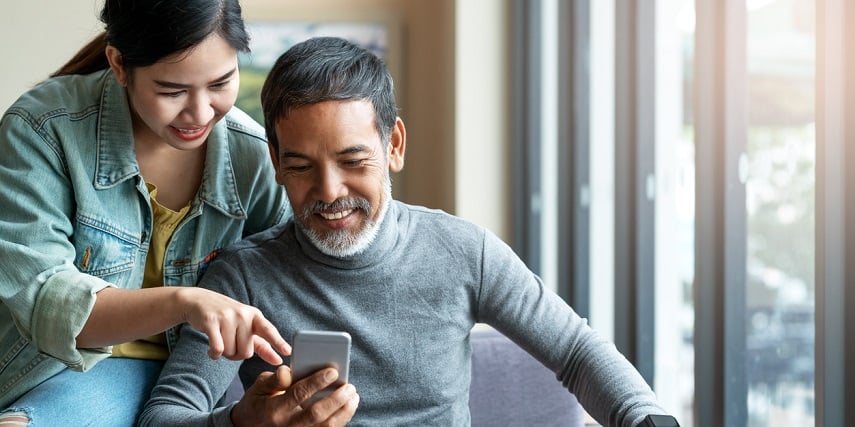 Father and teenage daughter looking at a 360 product viewer