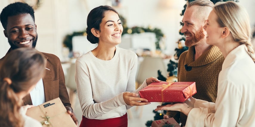 Friends exchanging gifts purchased through visual configuration for holiday shopping