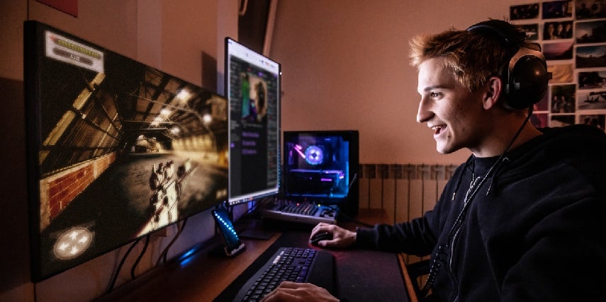 Gamer playing on a computer setup he purchased in a Magento product configurator