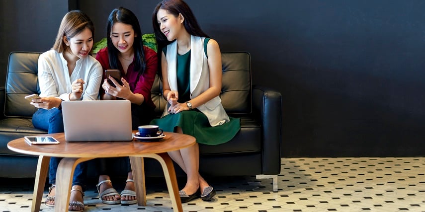 Group of friends shopping online using a laptop, phone, and a 360-degree photo viewer for PC users