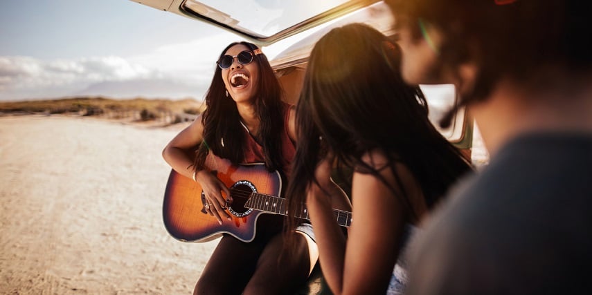 Group of friends with custom guitars they made in a guitar configurator