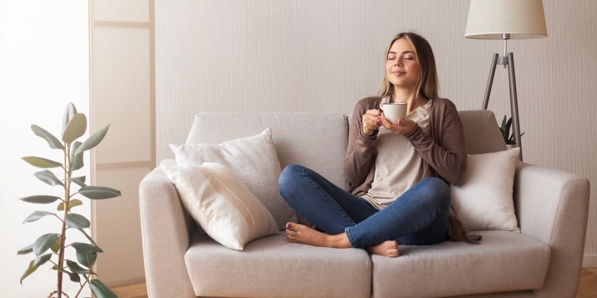 Homeowner relaxing on a custom couch she purchased through a 360 product viewer