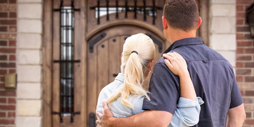 Homeowners looking at the newly installed front door they designed in a Magento product configurator