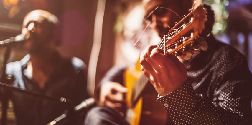 Man playing a guitar he built in a custom guitar configurator