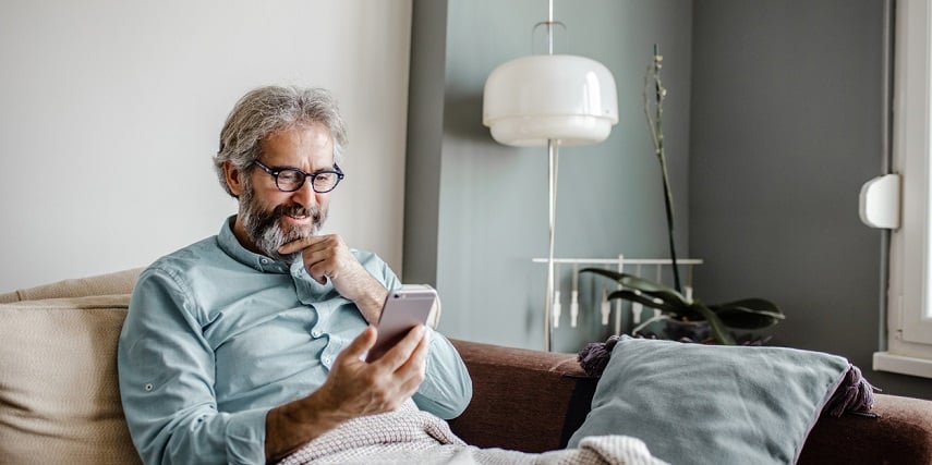 Man shopping at home and using a 3D configurator on his phone