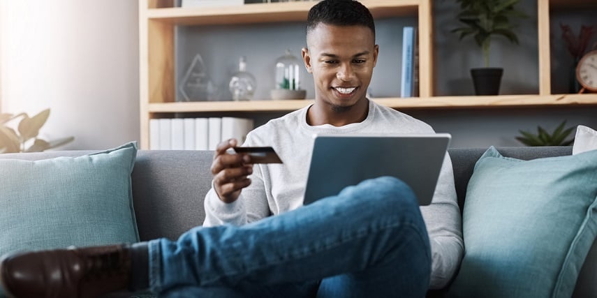 Man shopping online on his laptop at home