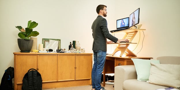 Man working at a standing desk he bought through a 3D customizer