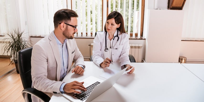 Medical professional and salesperson looking at options in a visual configurator