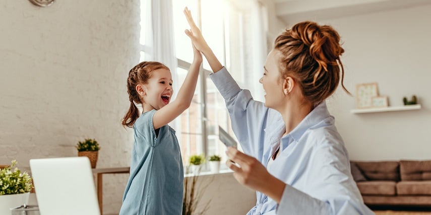 Mother and daughter high-fiving after creating a gift in a product customizer