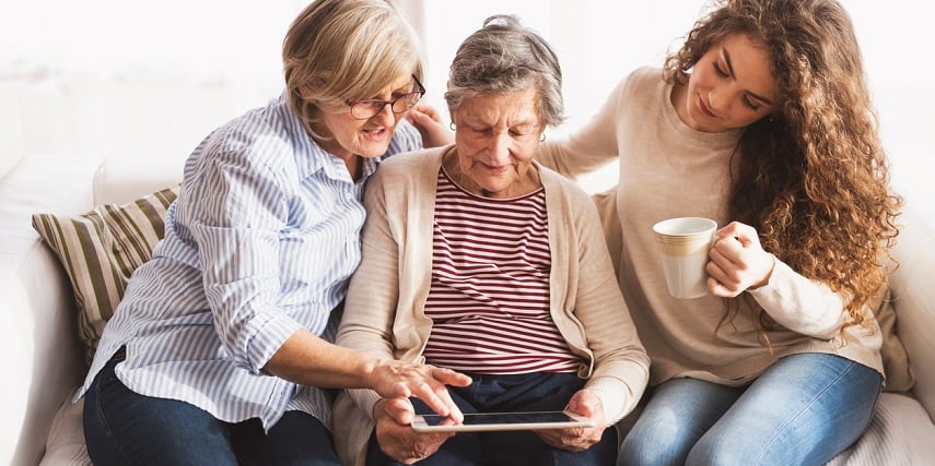 Mother, daughter, and grandmother exploring SAP product configuration options on a tablet