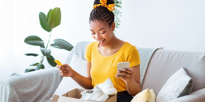 Online shopper opening the box of custom shoes they made in a 3D customizer