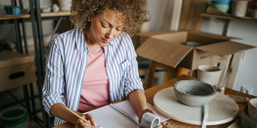 Pottery shop owner organizing inventory to optimize their online product configurator
