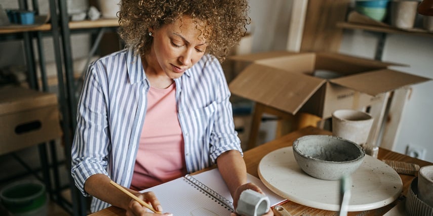 Pottery shop owner organizing inventory to optimize their online product configurator