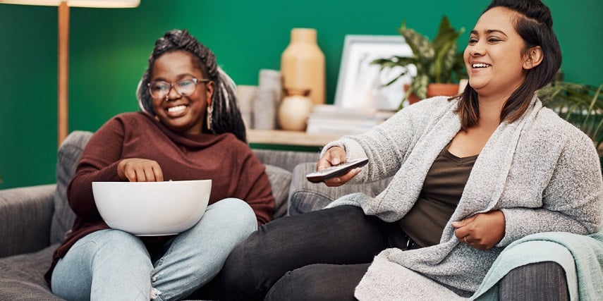 Roommates relaxing on a new couch ordered through a couch configurator