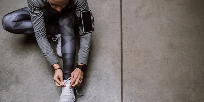 Runner tightening new shoes she customized in an Adidas shoe configurator