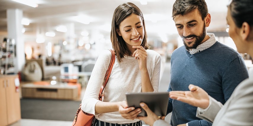 Sales rep and customers using a Magento product configurator in a store