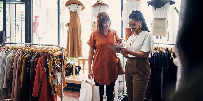 Salesperson in a store using product customization to help a customer