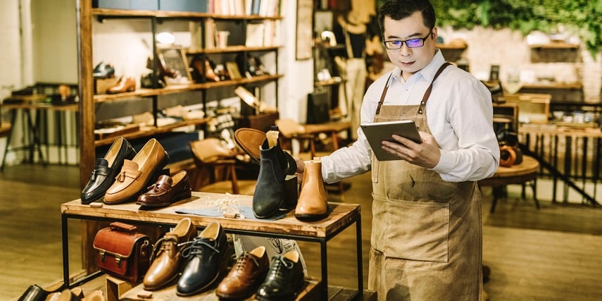 Shoe store owner using shoe configurator data to organize inventory and in-store displays