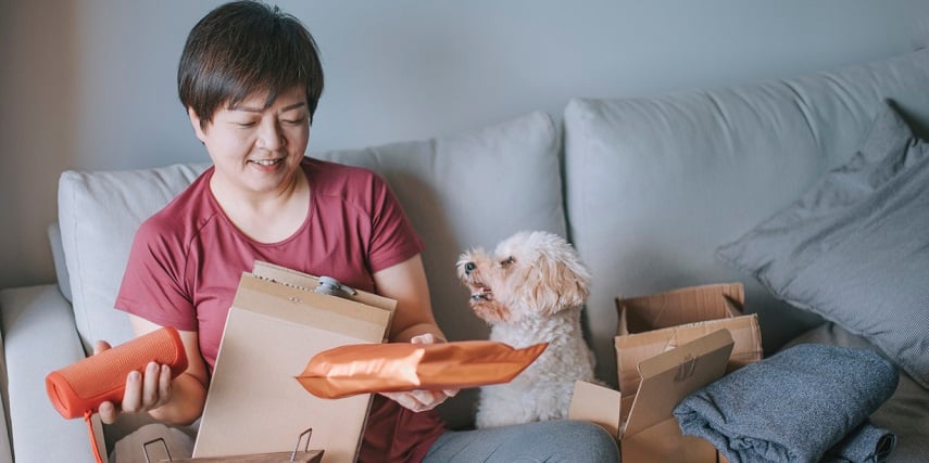 Shopper opening package of environmentally-friendly products she customized in a BigCommerce product configurator