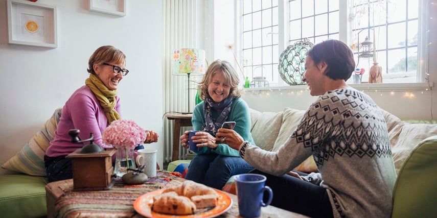 Shopper showing friends a custom product made in a Shopify product customizer