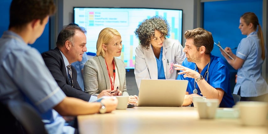 Team of medical administrators using a 3D customizer to optimize their lab equipment