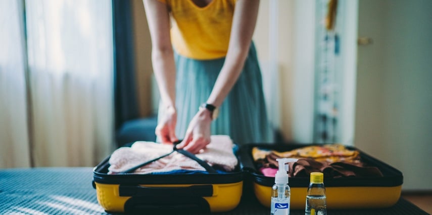 Traveler packing a yellow suitcase she created through a product customizer