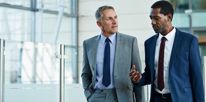 Two executives talking and wearing suits made through a 3D customizer