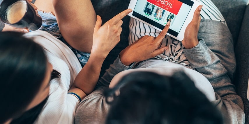 Two friends looking at an online sale