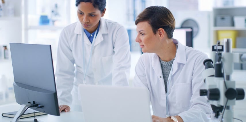 Two lab techs looking at a purchase through a 3D customizer