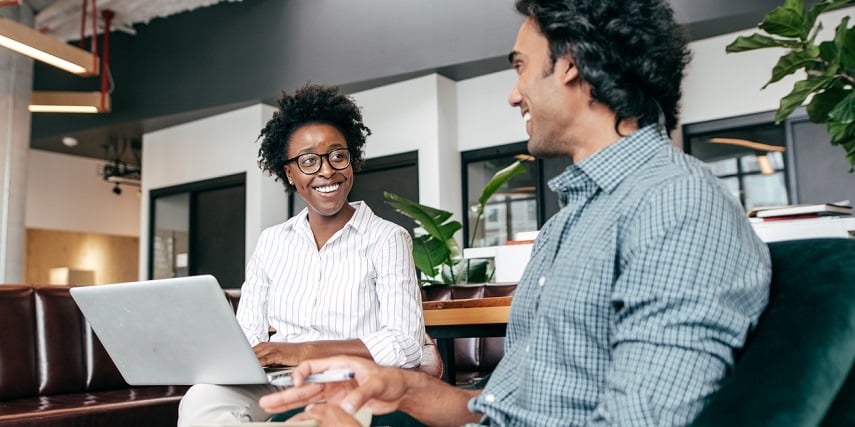 Two marketers smiling as product customizer software makes their PIM system run better