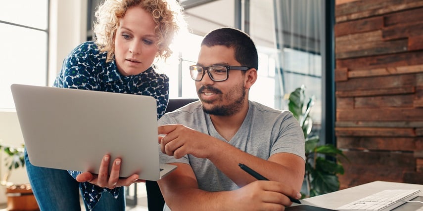 Two people looking at sublimation printed products through a product customizer