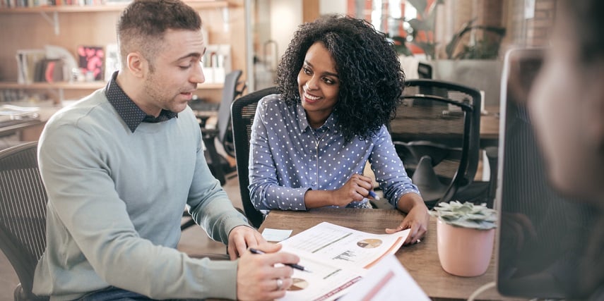 Two professionals analyzing data from a Salesforce product configurator