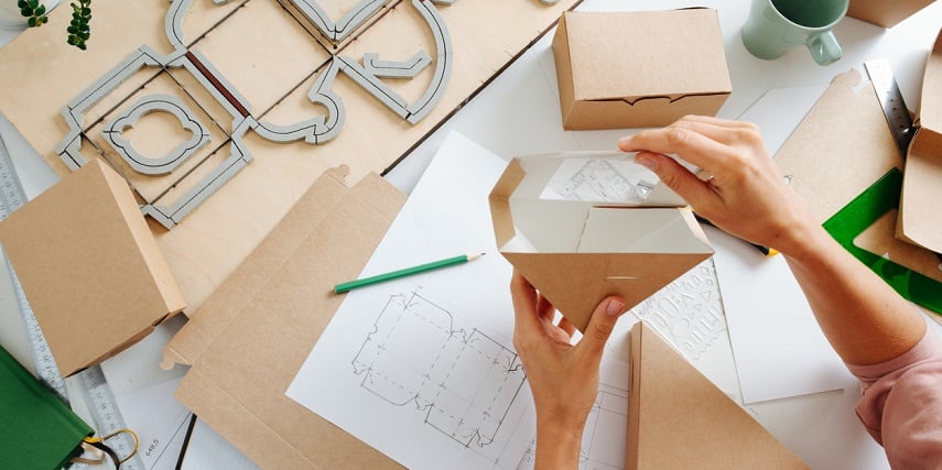 Woman assembling custom boxes created through a product configurator