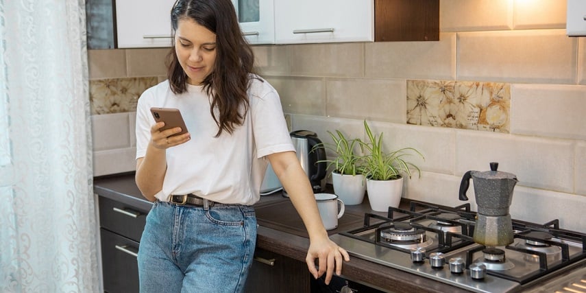 Woman browsing product customization options for new pots and pans