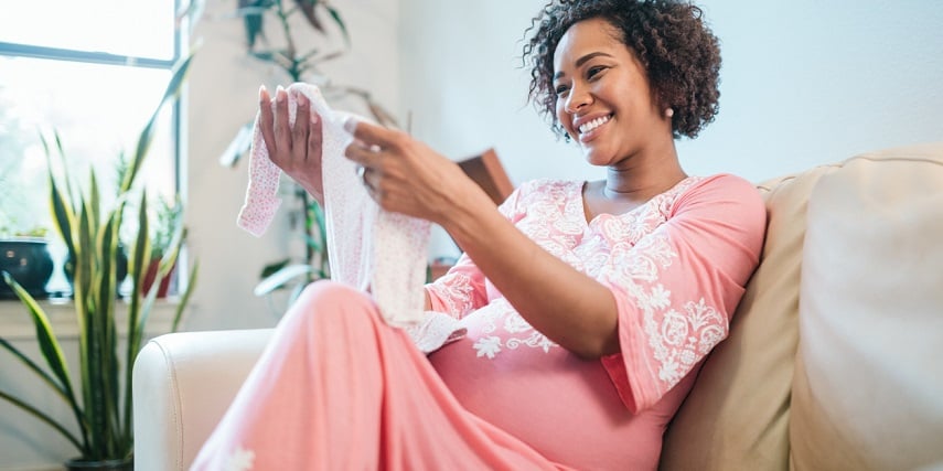 Woman opening personalized baby products made through a product customizer