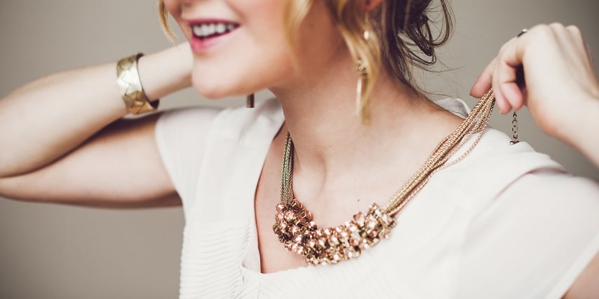 Woman putting on a custom necklace