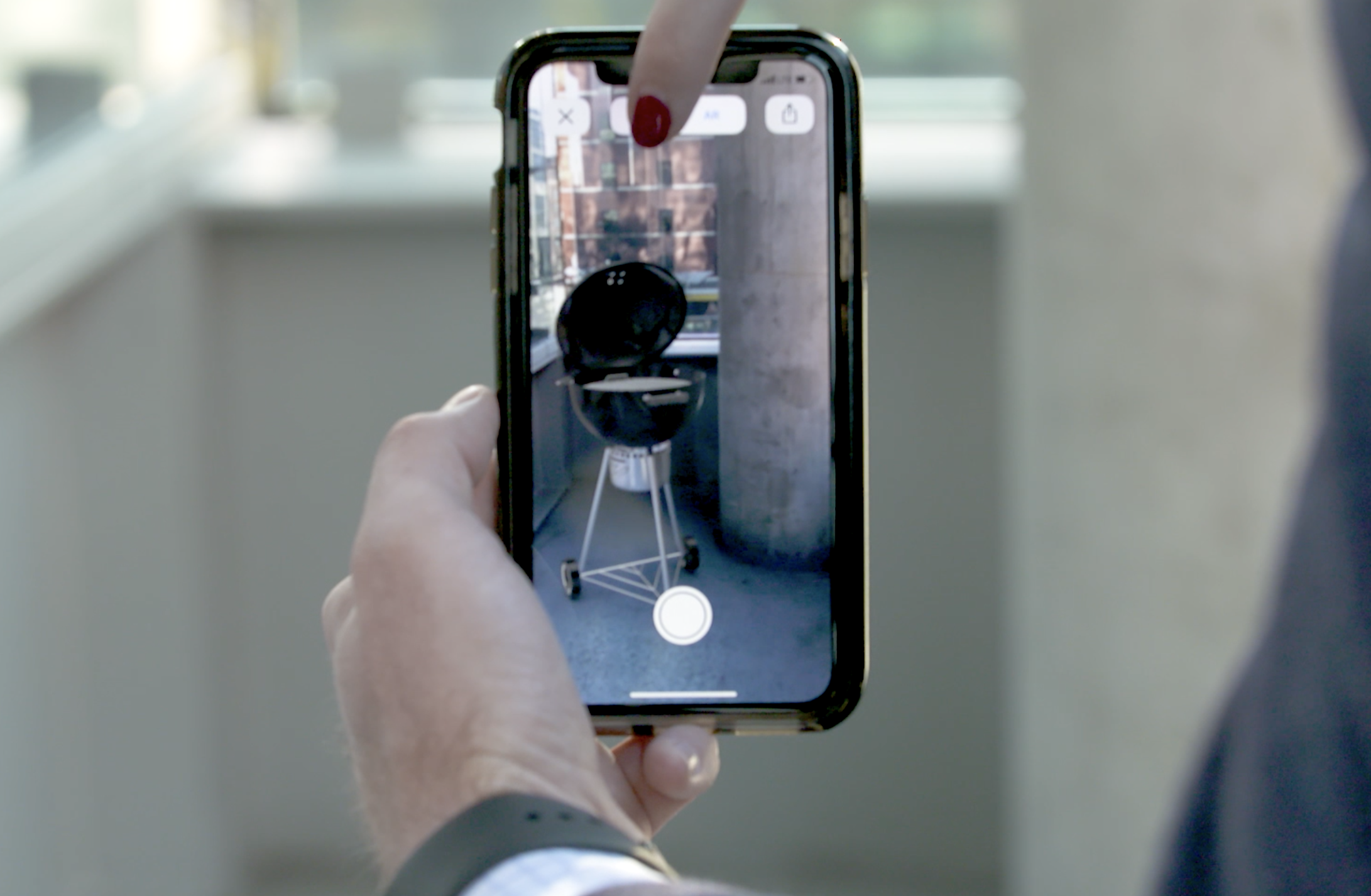 Mobile screen showing AR with finger 