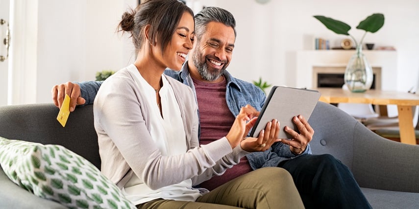 Couple having fun using 3D product configuration as they shop online