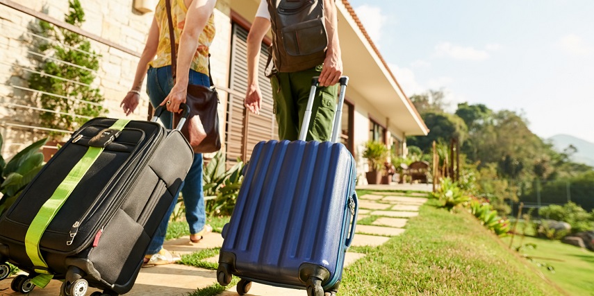 Two travelers with custom luggage they ordered through a WooCommerce product configurator